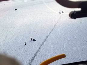 Ice fishers are stranded on Lake St. Clair near Mitchell's Bay on Jan. 30. Three were rescued by a helicopter crew from the U.S. Coast Guard's Air Station Detroit. Lt. Drew Caudill Photo/Courtesy of U.S. Coast Guard