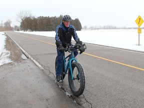 Inclement weather can't keep 78-year-old Walter Phillips from cycling more than 20 kilometres daily to stay physically fit and keep his diabetes in check. He is seen here Saturday cycling on Riverview Line just outside of Chatham. Ellwood Shreve/Chatham Daily News/Postmedia Network