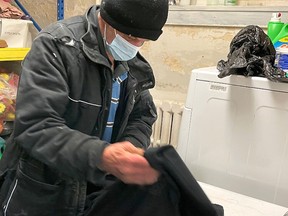 Handout/Chatham Daily News
A client uses the laundry facilities available at Chatham Hope Haven, which is open from 10 a.m. to 2 p.m. daily, to serve as a warming centre.