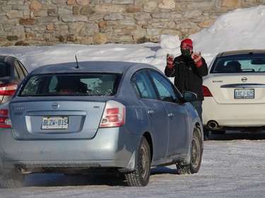 Organizing traffic at the parking lot mass. Photo on Sunday, January 31, 2021, in St. Andrews West, Ont. Todd Hambleton/Cornwall Standard-Freeholder/Postmedia Network