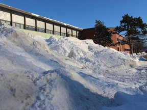 A mountain of snow along Sydney Street in downtown Cornwall, at CCVS. Cornwall. Photo on Thursday, February 4, 2021, in Cornwall, Ont. Todd Hambleton/Cornwall Standard-Freeholder/Postmedia Network