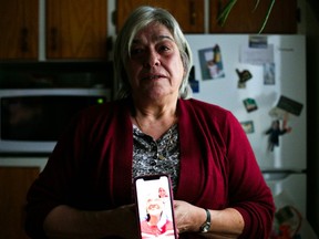 Joanne Carbonnell stands in the kitchen of her home with a photo of her mother, and becomes emotional when talking about her care at the Cornwall Community Hospital. Seen on Jan. 7, 2021. Jordan Haworth/Cornwall Standard-Freeholder/Postmedia Network Supplied