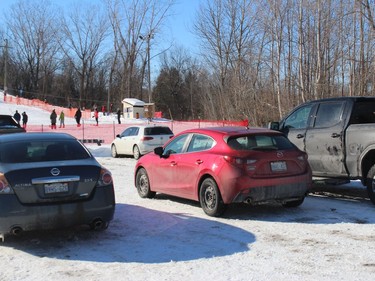 The parking area at Big Ben, and parents in the distance at the base of the hill, watching the action. Photo on Sunday, February 21, 2021, in Cornwall, Ont. Todd Hambleton/Cornwall Standard-Freeholder/Postmedia Network