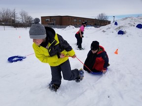 Notre-Dame school student Malyx Bergeron-Dinelle on his snowshoes and pulling Jonathan Trudeau, as Patrick Lafreniere looks on. Handout/Cornwall Standard-Freeholder/Postmedia Network

Handout Not For Resale