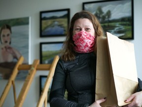 Staecy Lauzon, a volunteer for The Art of Recycling, holds a giveaway bag on Feb. 27, 2021 in Cornwall, Ont. Jordan Haworth/Cornwall Standard-Freeholder/Postmedia Network