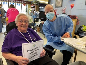 Handout/Cornwall Standard-Freeholder/Postmedia Network
Dundas Manor resident Annie Bouwhuis, left, was among those who received their second dose of the Pfizer-BioNTech COVID-19 vaccine, from Cornwall-SDG paramedic service paramedic Mike, in Winchester, on Saturday, Feb. 6, 2021.

Handout Not For Resale