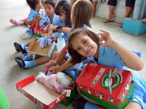 Handout/Cornwall Standard-Freeholder/Postmedia Network
A Frank King photo of children in Costa Rica receiving boxes from Canadians containing school supplies, hygiene products, toys, pictures, and notes.

Handout Not For Resale