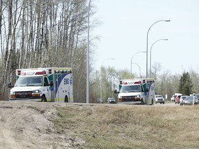Ambulances head south near Gregoire Lake, near Anzac, Alta., on Wednesday May 4, 2016. Photo by Ian Kucerak