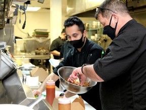 An employee makes a meal in the 57 North Kitchen and Brewery kitchen on Wednesday, February 3, 2021. Laura Beamish/Fort McMurray Today/Postmedia Network