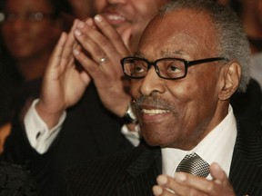 Barack Obama fan and former Ontario lieutenant-governor Lincoln Alexander applauds Obama's inauguration at an Obama Day celebration at University of Toronto Schools in January 2009.