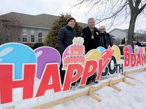 Lee McNaughton stands with his friends Jack and Jill Aldridge in a west-end Kingston neighbourhood on Saturday. McNaughton arranged a surprise outdoor birthday drop-by to mark his friend's 80th birthday.