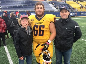 Josh Mosley, middle, an offensive lineman with the Queen's Gaels, with Jim Goobie, left, a Bayridge Secondary School student who takes part in Queen's University's Autism Mentorship Program, and his father, Jon, in a 2018 photo.