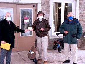 Mayor Ted Lojko of Gananoque presents a plaque to Peter Murray as Doug Bickerton looks on. Murray was recognized for his contributions to the town during his 24 years of service to the Gananoque Trails and Trees Advisory Panel.  
Supplied by Doug Bickerton