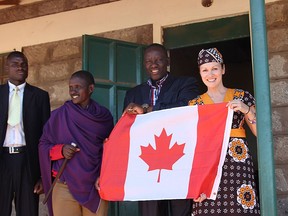 Nancy Stevens holds a Canadian flag with Kenyan officials after the construction of a school in Kenya in 2018. Stevens has been awarded a Meritorious Service Decorations from the Governor General's office.
