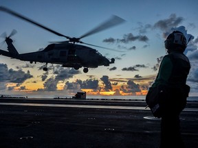 An MH-60R Sea Hawk helicopter launches during flight operations aboard the U.S. Navy aircraft carrier USS Ronald Reagan in the South China Sea on July 17, 2020.