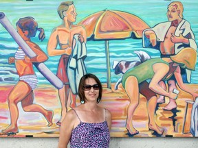 Above is Meaford's Suzette Terry with one of her murals that was installed on the Grand Bend beach house in 2018 as part of "The Beach House Mural Project."