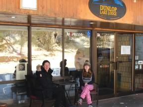 Photo by KEVIN McSHEFFREY/THE STANDARD
Tricia MacDonald, and her daughter Willa, outside of Dunlop Lake Lodge on a bright sunny winter’s day. She says the lodge is still open, only the indoor dining is currently closed.