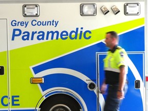 Grey County paramedic Joe Draper walks past an ambulance at the service's headquarters in Owen Sound in this file photo from July 23, 2019.