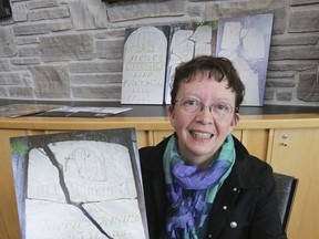 Naomi Norquay, president of the Old Durham Road Pioneer Cemetery Committee, holds a photograph of one of four Black pioneer headstones in this file photo from April 2015.