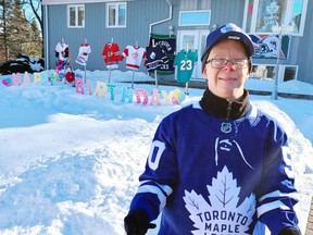 Pembroke's Jason Stewart is all smiles as he shows off his brand new Toronto Maple Leafs jersey, a present for his 50th birthday on Feb. 3. His mom Janet Baird decorated their front yard with jerseys from some of his other favourite teams and a Happy Birthday sign to mark the milestone.