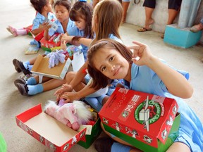 Children in Costa Rica open their gift-filled shoeboxes from Operation Christmas Child.