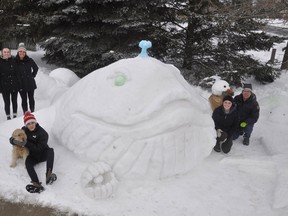 The Smith family of 86 Napier Street in Mitchell - Megan (left), Alison, Aiden (with Copper), Sydney and Dean - were just one of 11 families to be a part of the Upper Thames Missionary Church Family Day snow sculpture contest Feb. 15. Their depiction of Jonah and the Whale measured 16-feet long and six-feet high, and took approximately 10-hours to build on their front lawn. ANDY BADER/MITCHELL ADVOCATE