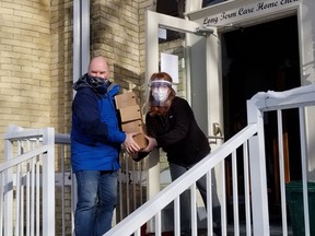 Candice Chartier, a staff member at the Seaforth Long Term Care and Retirement Residence, accepts donations from resident Bryan Vincent on behalf of the community who have rallied behind the long-term care home amidst a COVID-19 outbreak. Handout