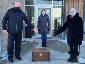 St. Marys Homecoming committee members John Flanagan, left, and Jackie Cousins, right, present a time capsule to St. Marys Museum curator Amy Cubberley. The time capsule was originally to be a snapshot of life in St. Marys in 2020 but evolved into a capsule of life during the COVID-19 pandemic. (Submitted photo)