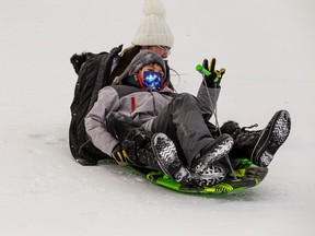 Emery Chowace, 12, and Eli Cardinal, 8, race down Borstad Lookout on a sled as they enjoy the outdoors on Family Day Monday.
RANDY VANDERVEEN