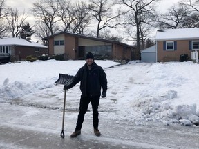 Kurtis Lush, with the Age-Friendly Sarnia-Lambton Adopt-a-Driveway program, poses by a shoveled driveway last year. The program is being insured by the City of Sarnia so it can continue and expand in the city. (Submitted)