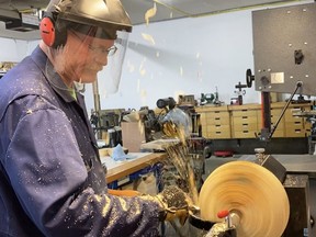 Doug McCuaig is seen here in his shop using a wood lathe to make a wooden bowl. He and his wife Jacqueline recently turned their hobby into a small business called Whimsical What Knots. Submitted photo.