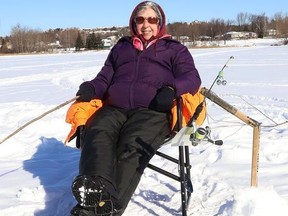 Micheline Denomme enjoys the sunshine while ice fishing on Robinson Lake in Sudbury, Ont. The weather for Wednesday calls for sunny skies and a high of -10 C.