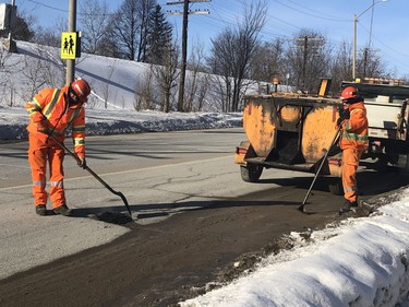 A city crew patches a pothole on Frood Road Monday morning. Harold Carmichael/Sudbury Star/Postmedia Network