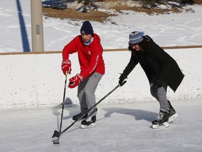 Brady Beaulieu and his mom, Christi-Ann, sharpen their hockey skills at the rink at Delki Dozzi Memorial Park in Sudbury, Ont. on Tuesday February 2, 2021.