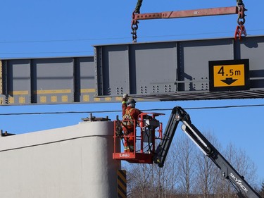 Workers install a section of Vale's railway bridge in Copper Cliff, Ont. on Wednesday February 3, 2021. The city said in a release that work on the bridge will close the southbound lane all day Thursday and the centre lane all day Friday. Motorists can expect delays. John Lappa/Sudbury Star/Postmedia Network