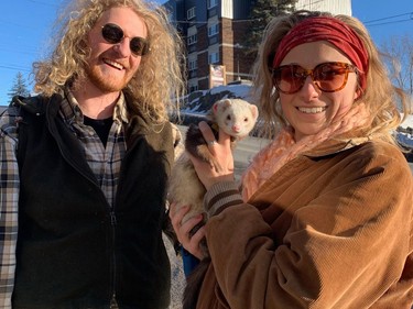 Thomas Lewis and Melanie Vanco enjoy the sunny, mild weather on Wednesday with their ferret friend Mashooshay. Jim Moodie/Sudbury Star