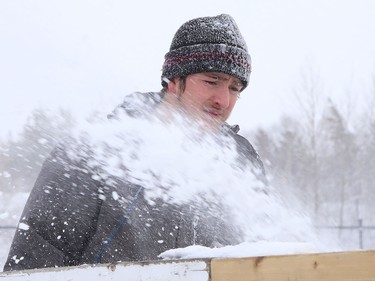 City employee Brady Moore uses a snowblower to clear snow off the rink at Elm West Playground in Sudbury, Ont. on Friday February 5, 2021. John Lappa/Sudbury Star/Postmedia Network