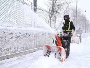 City employee Tyler Brady uses a snowblower to clear snow off the rink at Elm West Playground in Sudbury, Ont. on Friday February 5, 2021. John Lappa/Sudbury Star/Postmedia Network
