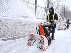 City employee Tyler Brady uses a snowblower to clear snow off the rink at Elm West Playground in Sudbury, Ont. on Friday February 5, 2021. John Lappa/Sudbury Star/Postmedia Network