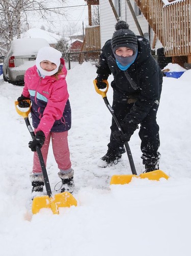 Selena Wuthrich-Giroux, 9, and her brother, Oliver, 14, clear snow off their driveway in Gatchell on Friday February 5, 2021. John Lappa/Sudbury Star/Postmedia Network