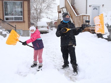 Selena Wuthrich-Giroux, 9, and her brother, Oliver, 14, clear snow off their driveway in Gatchell on Friday February 5, 2021. John Lappa/Sudbury Star/Postmedia Network