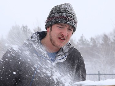 City employee Brady Moore uses a snowblower to clear snow off the rink at Elm West Playground in Sudbury, Ont. on Friday February 5, 2021. John Lappa/Sudbury Star/Postmedia Network