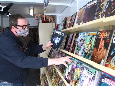 Cal Abram, owner of Comics North on Elm Street in Sudbury, Ont., checks inventory on Tuesday February 16, 2021. The local business has reopened after having to close because of the second province-wide shutdown. John Lappa/Sudbury Star/Postmedia Network