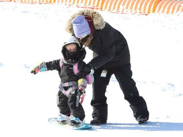 Dana Cuddy keeps a watchful eye on her daughter, Tori, 3, as the little one learns to snowboard at Adanac Ski Hill in Sudbury, Ont. on Wednesday February 17, 2021. Both Adanac and Lively Ski Hill opened for the season on Wednesday. Operations have been adapted in response to COVID-19. Patrons must book their tickets before arriving at either ski hill, as day tickets will not be available onsite. Those with memberships or punch cards are also required to book ahead. Booking can be done online at www.greatersudbury.ca/leisure. John Lappa/Sudbury Star/Postmedia Network