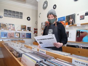 Mark Browning, of Cosmic Dave's Vinyl Emporium on Kathleen Street in Sudbury, Ont., checks over inventory on Wednesday February 17, 2021. The business has reopened after having to close because of the second province-wide lockdown. John Lappa/Sudbury Star/Postmedia Network