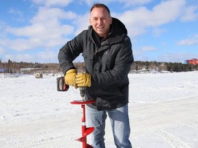 Andre Grandchamp, group manager of media sales at The Sudbury Star and North Bay Nugget, checks the thickness of the ice on Ramsey Lake in Sudbury, Ont. on Wednesday February 17, 2021. The annual Sudbury Star Ice Guessing contest has kicked off. John Lappa/Sudbury Star/Postmedia Network