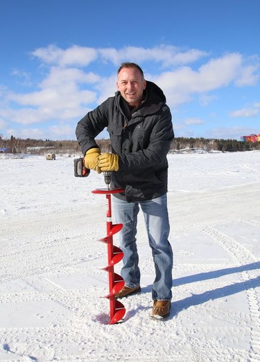 Andre Grandchamp, group manager of media sales at The Sudbury Star and North Bay Nugget, checks the thickness of the ice on Ramsey Lake in Sudbury, Ont. on Wednesday February 17, 2021. The annual Sudbury Star Ice Guessing contest has kicked off. John Lappa/Sudbury Star/Postmedia Network