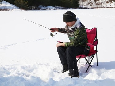 Donald Wade tries his luck at ice fishing at Lake Laurentian in Sudbury, Ont. on Thursday February 18, 2021. John Lappa/Sudbury Star/Postmedia Network