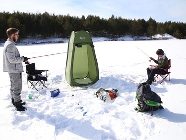 Joel Lapierre, left, and his son, Donald Wade, spent the afternoon ice fishing at Lake Laurentian in Sudbury, Ont. on Thursday February 18, 2021. John Lappa/Sudbury Star/Postmedia Network