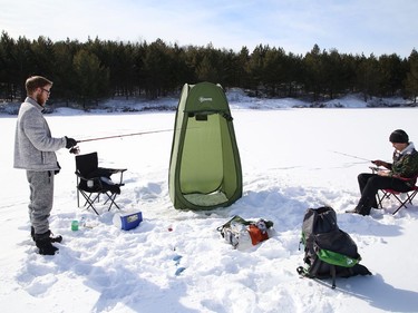 Joel Lapierre, left, and his son, Donald Wade, spent the afternoon ice fishing at Lake Laurentian in Sudbury, Ont. on Thursday February 18, 2021. John Lappa/Sudbury Star/Postmedia Network